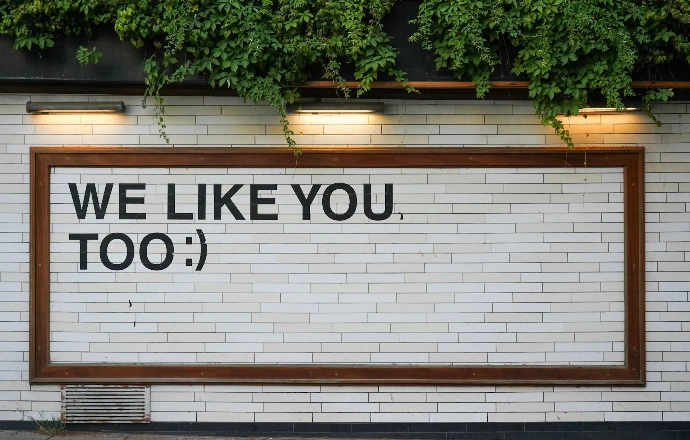 We Like You signage on white tile